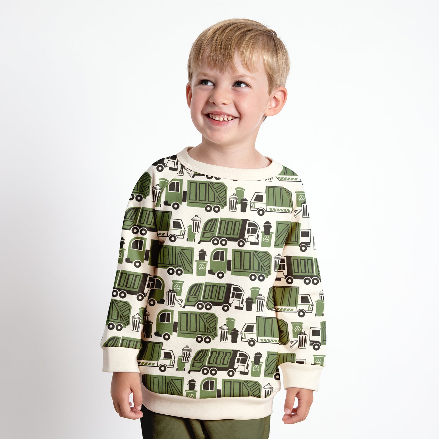 Child wearing green sweatshirt with garbage truck and recycling print, made with organic cotton